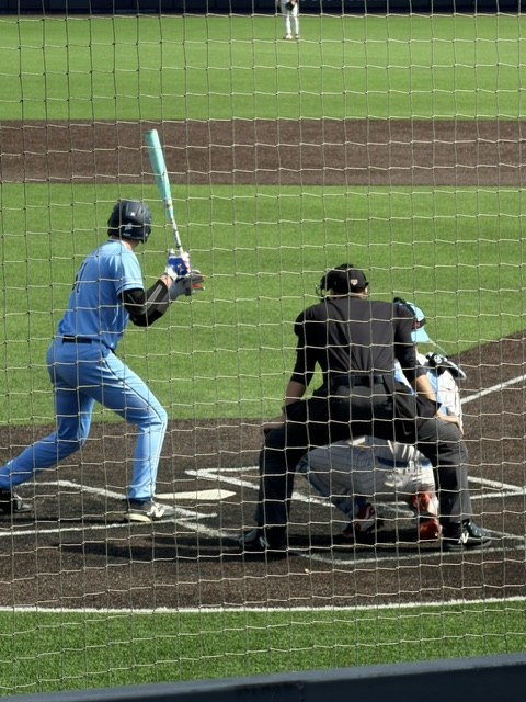 Nate Barker umpiring behind home plate